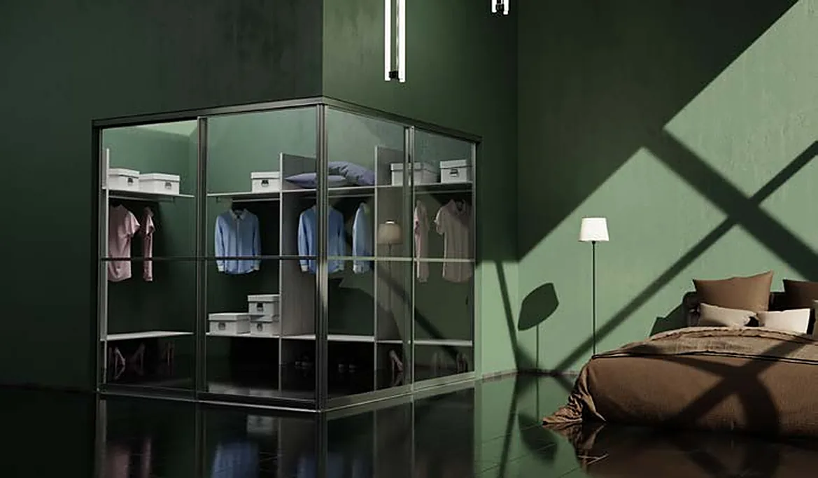 Corner wardrobe with aluminium-framed sliding glass doors in a green bedroom Corner wardrobe with aluminium-framed sliding glass doors in a green bedroom
