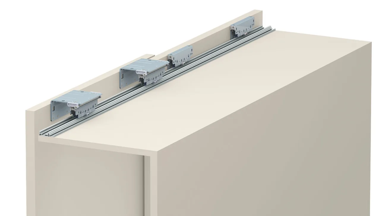 Evolution upper rail with several carriages fitted on top of a wardrobe carcass Evolution upper rail with several carriages fitted on top of a wardrobe carcass