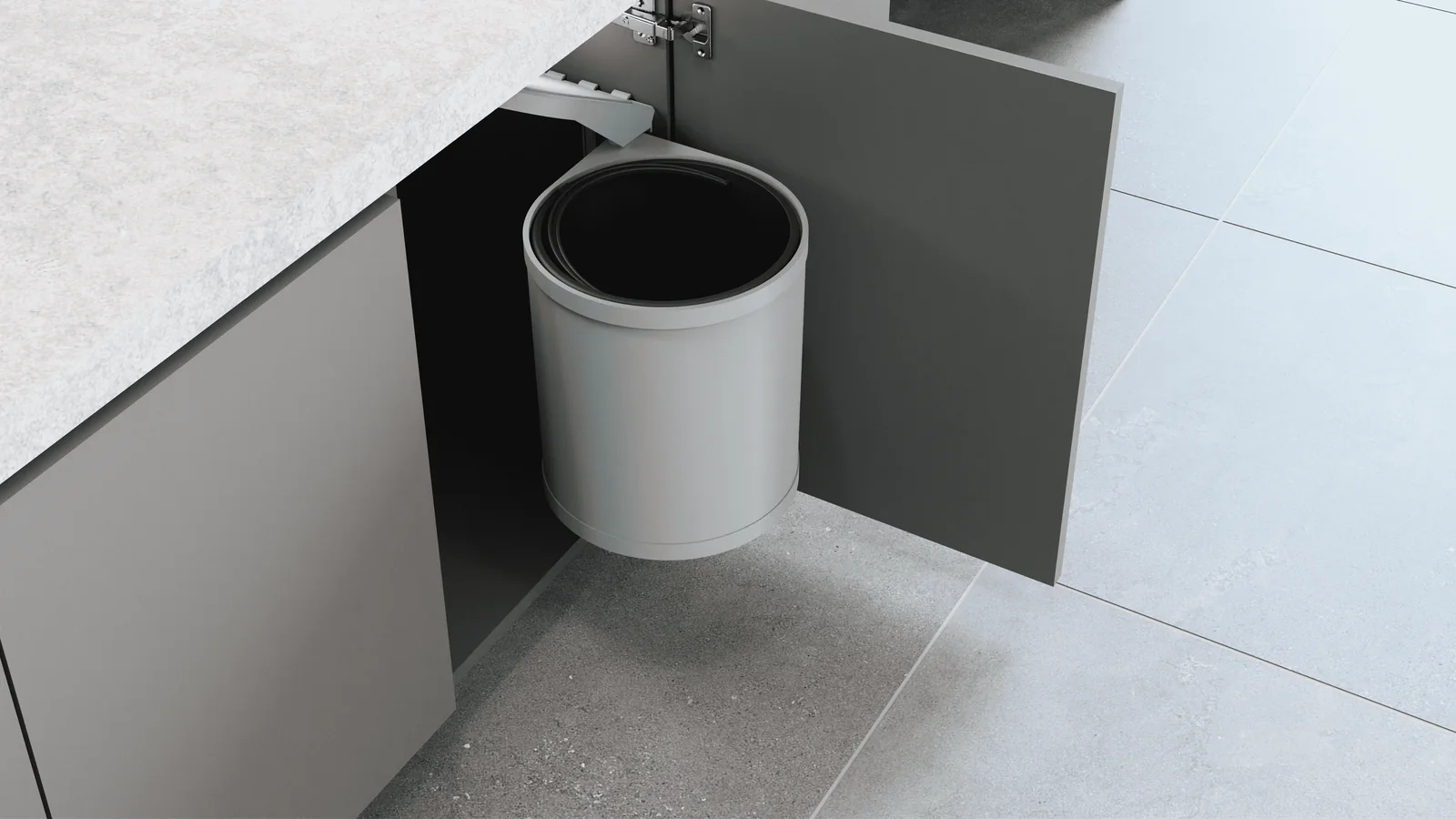 Ring round rotating waste bin mounted inside a modular kitchen base cabinet beside the open door